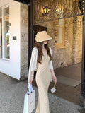 Knitting Season_Soft Sky Silk Sling With Two Sets Of White Knitted Cardigan Outside Sunscreen